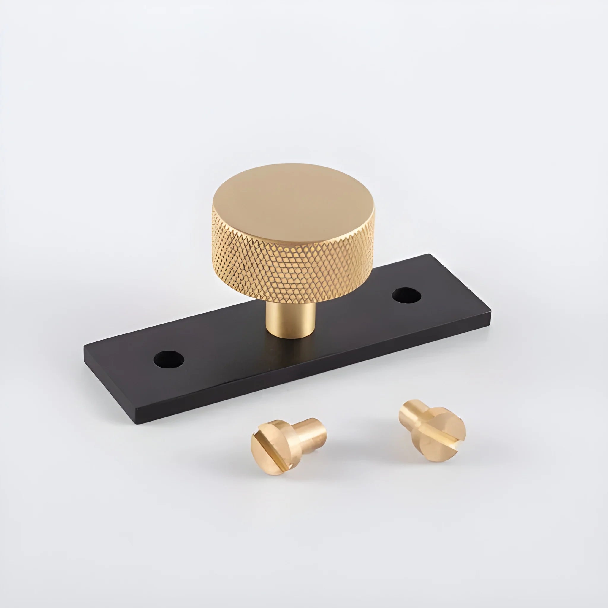 The Mantara B-0118 is a modern brass knob in gold with a black stabiliser base, ideal for kitchen and dresser drawers.