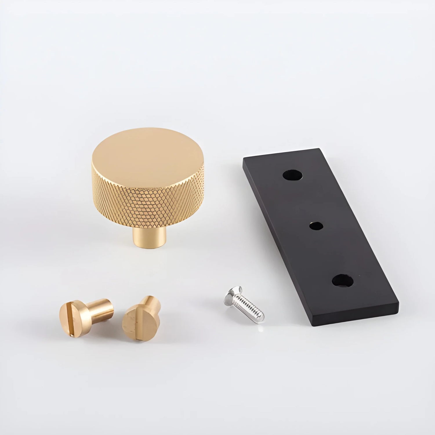 The Mantara B-0118 is a modern brass knob in gold with a black stabiliser base, ideal for kitchen and dresser drawers.