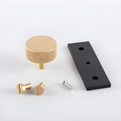 The Mantara B-0118 is a modern brass knob in gold with a black stabiliser base, ideal for kitchen and dresser drawers.