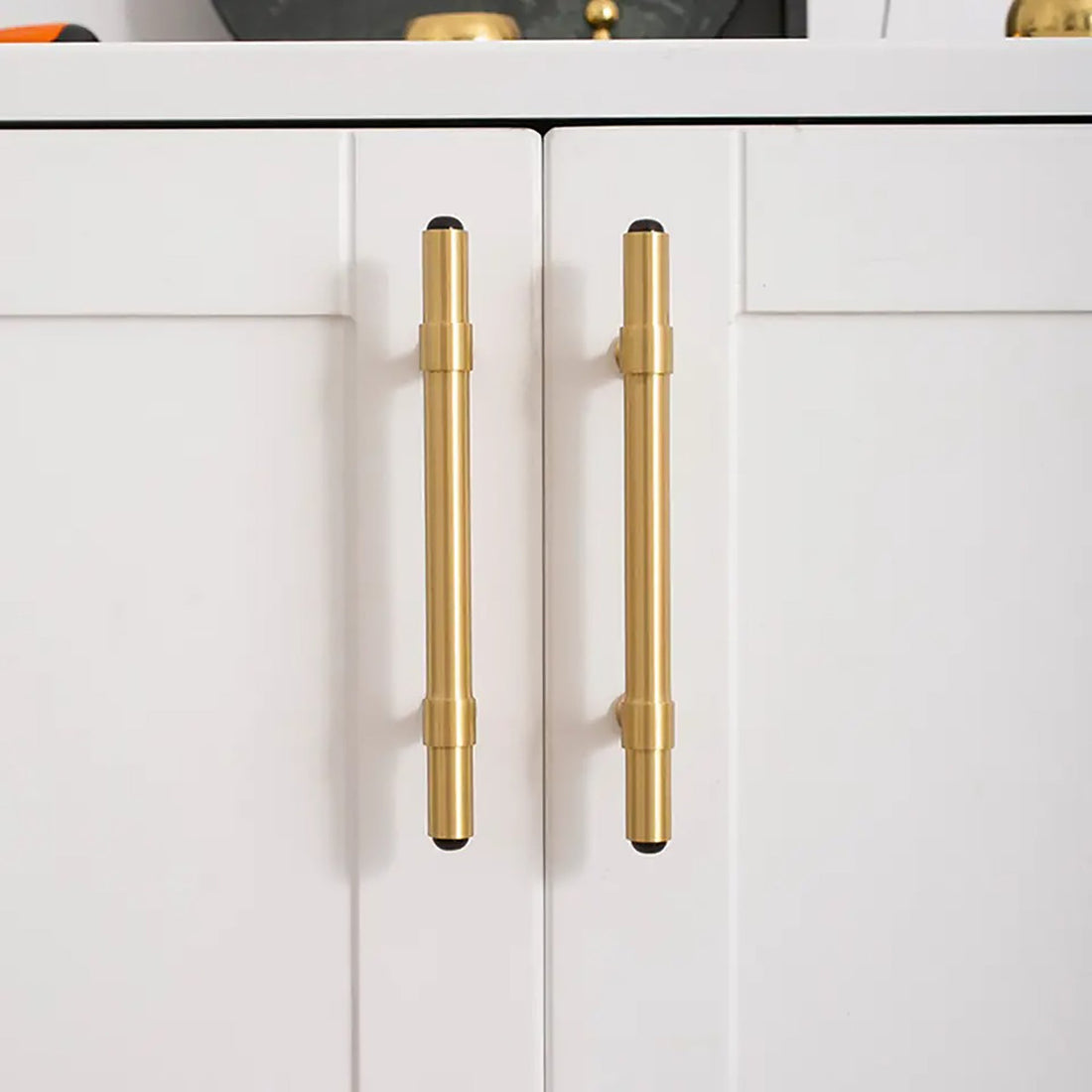 The Zania Handle by Mantara B-0111 is a modern brushed brass handle in gold, ideal for kitchens, dressers, and cabinets.