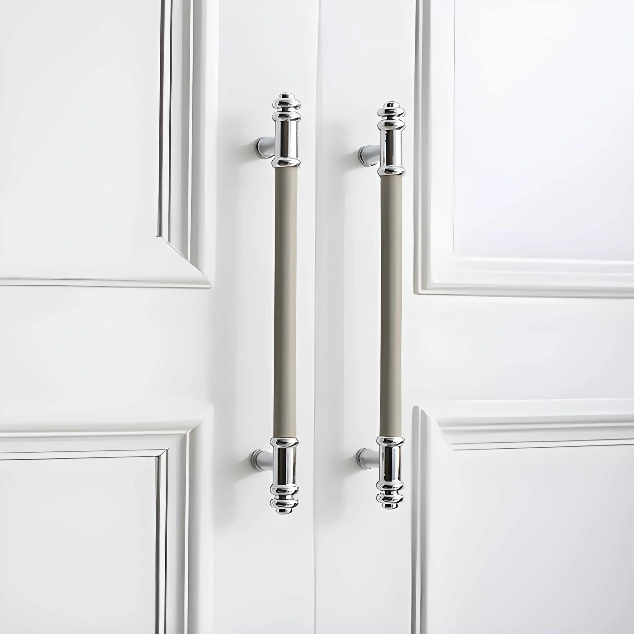 The Mantara L-0013 is a modern brass + leather handle in grey, ideal for kitchen drawers, dressers, and cabinets.
