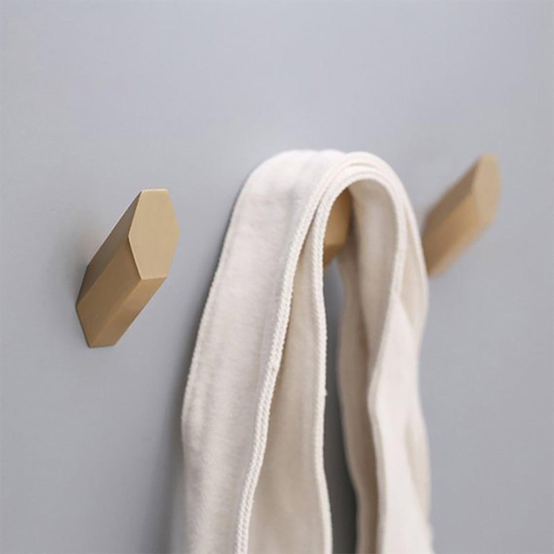 Mantara Hexa Hook B-0091 is a modern brushed brass wall hook in gold, perfect for bathrooms, bedrooms, and living areas.